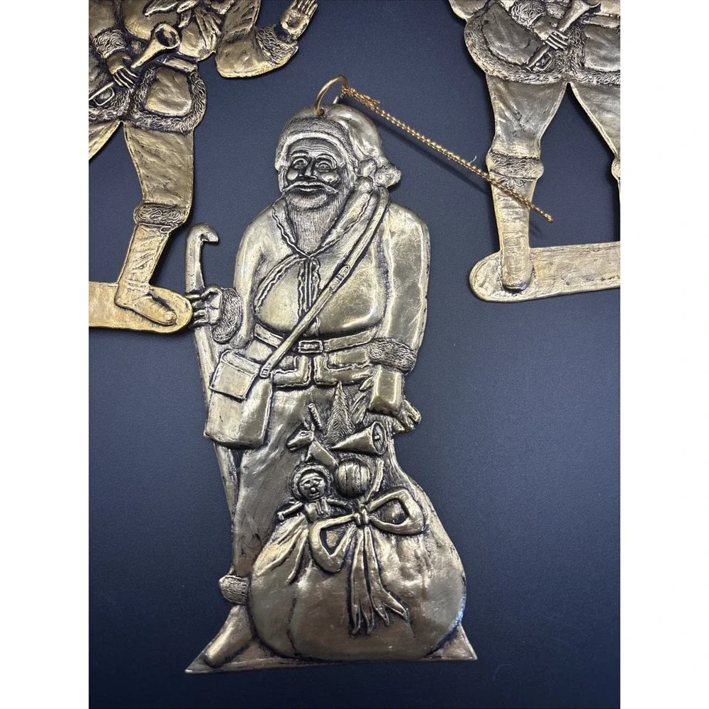 4 Vintage pressed‎ metal Santa with Gift Bag Christmas Tree ornaments aprox 6in.